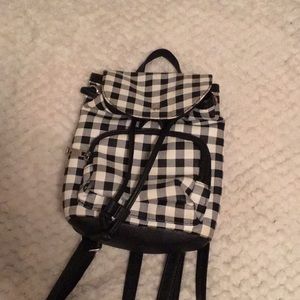 Mini backpack with white, gray and black plaid.